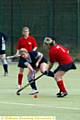 OLDHAM’S Rebecca Blair (blue) fends off a challenge to get her pass away. Picture: Chris Bull 