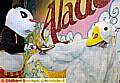 YOUR turn next . . . Peekoe the Panda passes the lamp to Mother Goose 