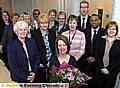Dr. Denise Munro (centre) receiving flowers from practice manager June Hunt (front left).