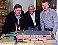 Paul Anderson (left) and grandson of the company founder, Barry Scott (centre), check out the Pine Mill model with Gallery Oldham’s Sean Baggaley 
