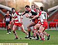 CHARGING THROUGH: Robert Roberts (centre) powers on through the tackles for Oldham.