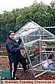 Project chairman Stephanie Wilde and the vandalised greenhouse at Alt Primary School’s community garden 