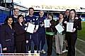 Students receive certificates from Latics players. From left, Tasneem Kausar-Javaid, tutor, Deane Smalley, Melissa Valentine, Sean Gregan, Danny Whittaker, Robyn Williams, Helen Wilson, Lee Duxbury and Ashleigh Winterburn 