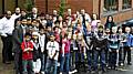 The youngsters, pictured with staff from Contour Homes and Oldham Athletic, show off their medals. 