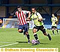 LATICS striker Chris O’Grady tussles for the ball 