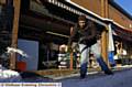 Nazrul Islam shovels snow to keep his stall clear 