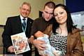 PROUD parents . . . Liam McAiney and Joanna Finch with their new-born baby Kobey and deputy registrar Stuart Ogden