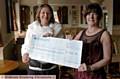 Dinner dance organiser Debbie Howarth (left) hands over the proceeds to Sheila Mitchell, fundraiser for the National Concern for Healthcare Infections. 
