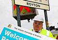 Flashback . . . Oldham’s Lib-Dem council leader Howard Sykes helps fit the first new sign in Royton 
