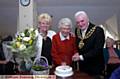 The Mayor and Mayoress, Councillors Jim McArdle and Kay Knox, help Miss Brierley slice her birthday cake 