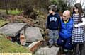 Stewart George and his children, Joe and Lucy, survey the damage after the refuse wagon wrecked their garden steps 
