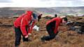GRIM search . . . the team probes the moor. 