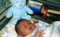 WATCHING over you . . . a picture of tragic Allison lies by the side of baby Jacob 
