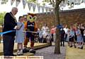 CUTTING the ribbon . . . Mayor of Oldham, Councillor Jim McArdle, pupil Shauna Clare (10) and Chaddy the Owl 
