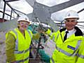 TOPPING out . . . Gloria Oates and Chief Constable Peter Fahy screw in a golden bolt 
