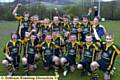 LOUD AND PROUD: Oldham St Anne’s under-12s celebrate with the Chronicle Cup. Man of the match Oliver Russell (left, centre) holds the trophy with captain Callum Fletcher 