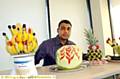 SAYING it with fruit . . . Yahhia Qurashi who produced the stunning design as part of a multi-cultural event by business management students 