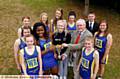 PICTURED (centre) with the trophy are Lynda Onuoha, from Hulme Grammar School, Amy Whitehead, from Oldham Sixth Form College, and Mike Greenwood. Looking on are members of the winning teams. 
