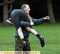 THIS WAY: Corporal Craig Mould gives one of the players a hand. 