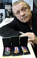 Ernie Townsend with his father’s war medals 