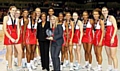 DELIGHT: England celebrate their World Netball Series success. Pictured are Jo Harten (left), Sara Bayman, Stacey Francis, Kadeen Corbin, Emma Dovey, Molly Rhone (IFNA president), Eboni Beckford Chambers, Anna Mayes (head coach), Sasha Corbin, Laura Malcolm, Jade Clarke (captain), Pamela Cookey, Serena Guthrie and Rachel Dunn. 