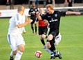 ON THE CHARGE . . . Athletic forward Chris Taylor runs at the Mossley back line. 