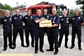FAREWELL... Watch Commander Mark Beswick (front left) receives an engraved axe from crew manager Tony Green at Oldham Fire Station. 
