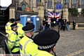 RALLY . . . the gathering is watched by police 
