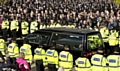 The hearse carrying murdered policewoman Nicola Hughes is driven from the cathedral as officers line the streets in tribute 
