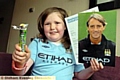 A DELIGHTED Megan Kinghorn with her fruit pastilles and signed photo and letter from Roberto Mancini. 