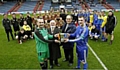 HERE WE GO . . . Kirkheaton skipper Mick Maddigan (front, left), Huddersfield and District League chairman Frank Beaumont, junior football official Eric Kershaw and Diggle captain Danny Cheetham hold the Barlow Cup with both teams looking on, ahead of last night’s final. 