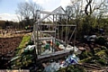 A brand new greenhouse smashed by vandals.