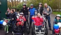 ON their bikes . . . Rhiain Harris-Larkin (back left) and Joanne McAllister (back, second right) with Huan and Megan (front) and supporters at the sponsored cycle ride 
