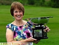 PAULINE RICHARDSON holds the Chronicle Cup. 