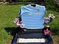 Manchester City shirt on headstone 

