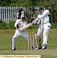 Glodwick's batsman Nigel Stock hits a four off Uppermill's bowler Mark Lees 
