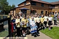 Fitting tribute: Max Durston and Lois Winterbottom from Watersheddings Primary School hold a picture of best friends Annie Walsh and Ivy Turner as they officially open the chicken-run tribute. 