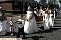 STRIDING OUT... St Paul’s Rose Queen, Lucy Mary Lingard with her retinue in Royton 

