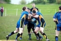 STUCK IN THE MIDDLE: Jack Hughes of Higginshaw charges into a trio of Ulverston players. 
