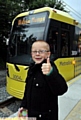THUMBS UP . . . Kian Sheldon, ready to board the first Metrolink tram to leave Oldham Mumps for Manchester Victoria. 