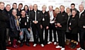 WEDDING gift . . . Sally and Alan (back fifth and sixth left) behind Francis Rossi (centre) and Rick Parfitt (right) and other fans backstage 
