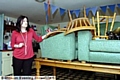FLOOD-HIT . . . Angela Brereton with her furniture which was stacked on a table to avoid water damage 
