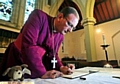 EXPRESSING our grief: the Bishop of Middleton signs the book of condolence at East Crompton St James Church 
