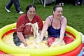 LONG to rain over us — in custard . . . Natalie Hughes (left) and Stacey Dennis braved a sponsored custard bath to raise money for the Scott Ward Schofield Fund and Crazy Cats charities during the Jubilee celebrations at Limeside Park 
