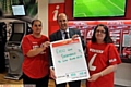 Keith McHugh receives his betting slip from Ladbrokes' Emma Moore and Janet Bradley (right). 
