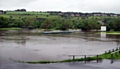 WATER, WATER, EVERYWHERE: the Saddleworth outfield last Friday after the River Tame burst its banks behind the ground at Well-i-Hole. 