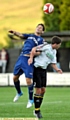 JUMP TO IT: Athletic midfielder Dean Furman climbs above his Mossley rival to win a header. 