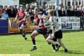 Jamie Dallimore tries to fend off a would-be Skolars tackler. 