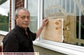 ANGRY: Andrew Tindall by the boarded-up window 
