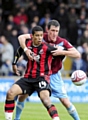 NO-NONSENSE DEFENDING . . . Cliff Byrne gets to grips with an opposition striker. 

